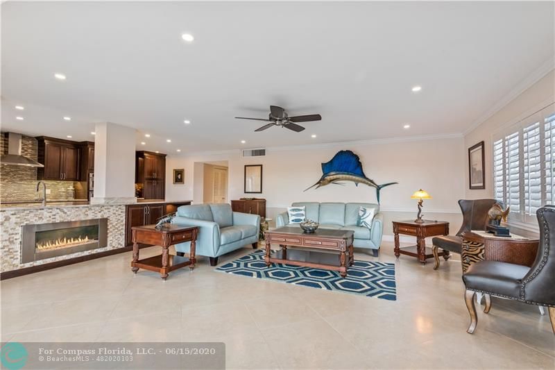 3050 Northeast 47th Court, Unit 301 Fort Lauderdale, FL 33308 - Photo 3 of 19 a living room with furniture and a fireplace