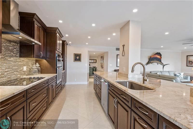 3050 Northeast 47th Court, Unit 301 Fort Lauderdale, FL 33308 - Photo 5 of 19 a kitchen with stainless steel appliances granite countertop a sink and a stove