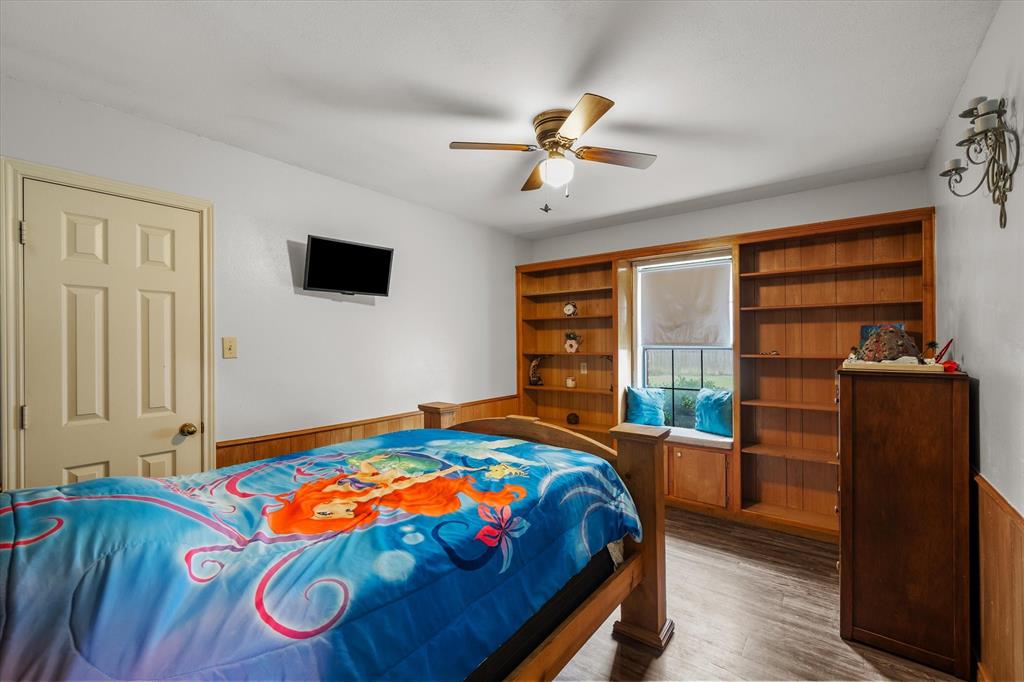 163 Granada Square Canton, TX 75103 - Photo 23 of 39 Bedroom with built-in shelving, window seat and walk-in closet