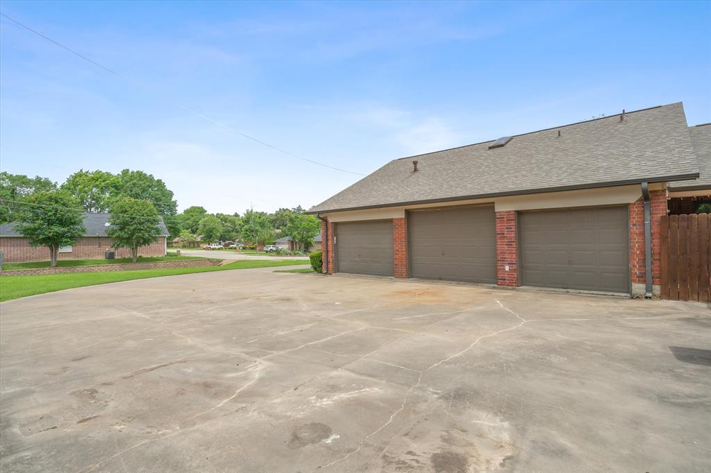 163 Granada Square Canton, TX 75103 - Photo 33 of 39 Plenty of parking with rear facing 3 car garage.
