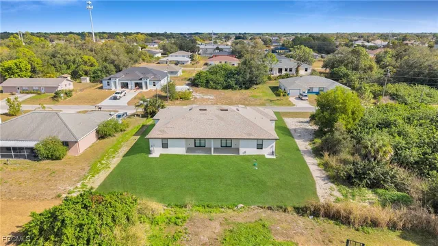 an aerial view of a house with a yard
