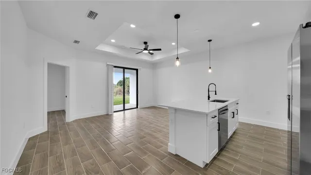 a view of a kitchen with a sink and a wooden floor