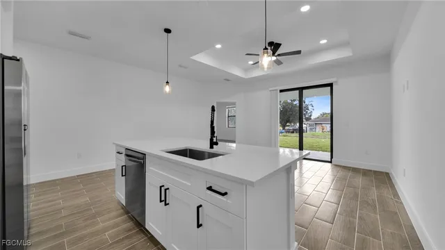 a kitchen with stainless steel appliances a sink and a refrigerator