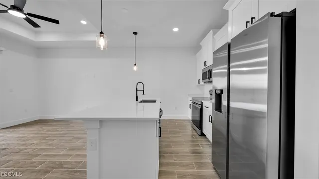 a kitchen with stainless steel appliances a refrigerator and a sink