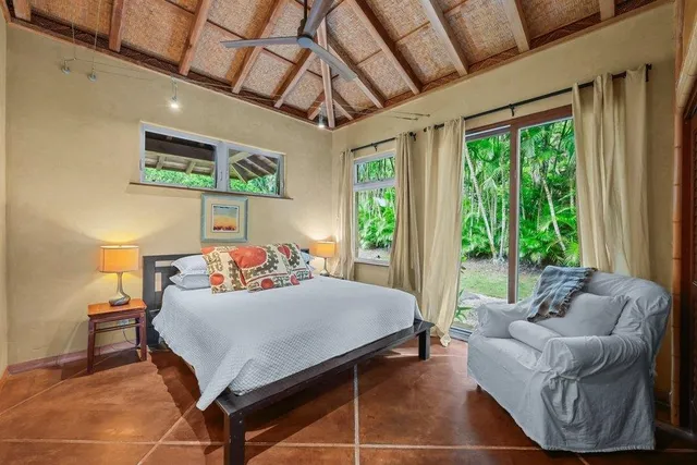 a bedroom with a large bed and a large window