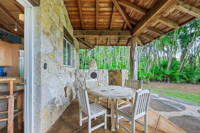 a view of a chairs and table in patio with wooden fence
