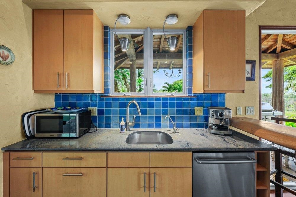 160 A Piialii Place Haiku, HI 96708 - Photo 5 of 22 a kitchen with kitchen island granite countertop a sink a stove and cabinets