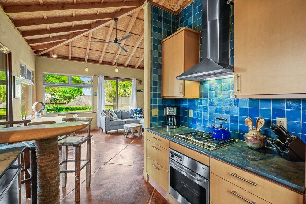 160 A Piialii Place Haiku, HI 96708 - Photo 6 of 22 a kitchen with a stove a sink and potted plant next to a window