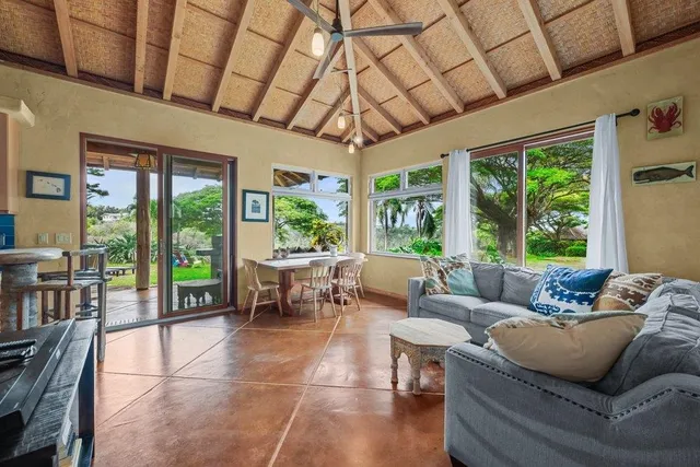 a living room with lots of furniture and a large window