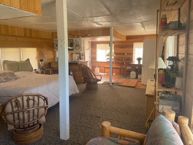 4648 West Taylor Flt Road Salina, UT 84654 - Photo 7 of 20 Expansive open-concept room featuring wood-paneled walls and a built-in shelving unit