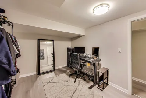 a view of a workspace with furniture and a window