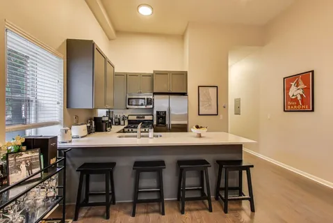 a view of a dining room kitchen with a sink and chairs