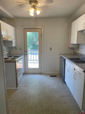 a kitchen with a stove a sink and a refrigerator