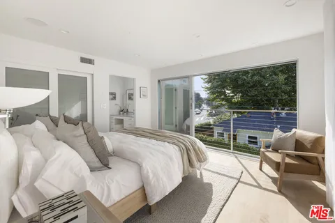 a bed room with a bed and a large window