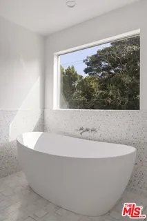 a white bath tub sitting in a bathroom