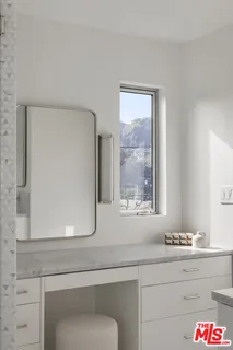 a bathroom with a sink and mirror
