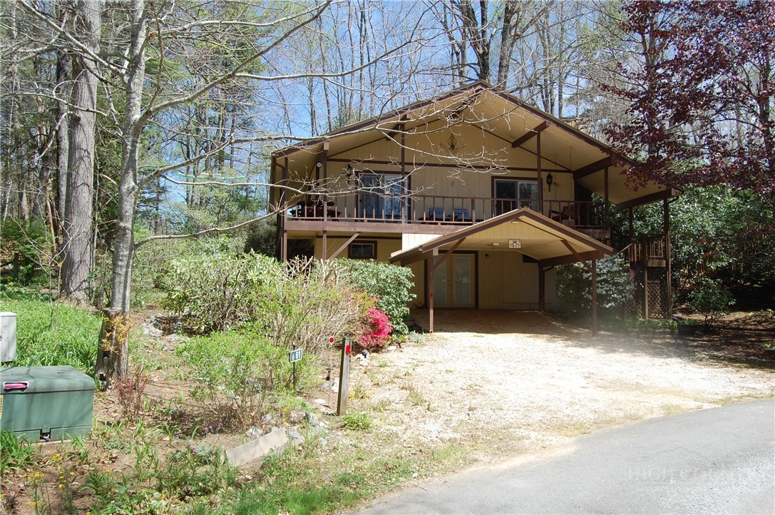61 Dew Drop Loop Newland, NC 28657 - Photo 1 of 26 a backyard of a house with wooden fence and plants