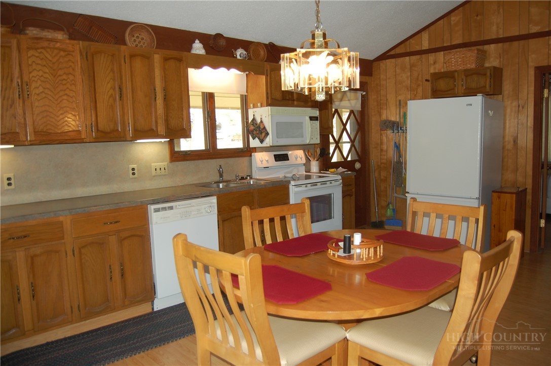 61 Dew Drop Loop Newland, NC 28657 - Photo 4 of 26 a view of a dining room with furniture and chandelier