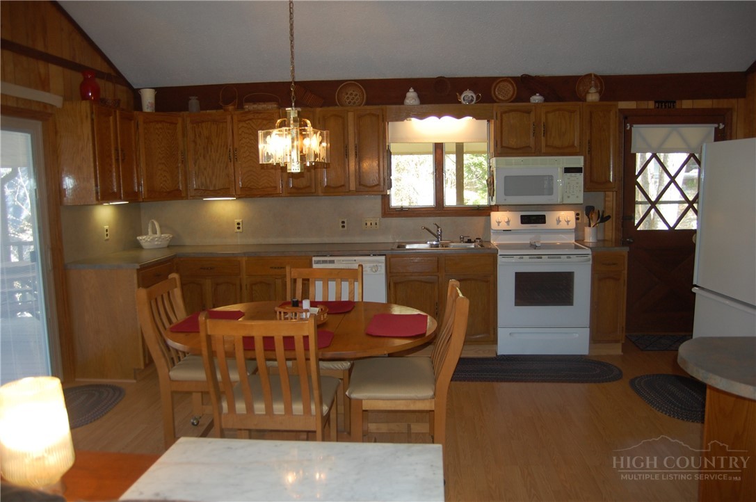 61 Dew Drop Loop Newland, NC 28657 - Photo 6 of 26 a kitchen with a dining table chairs and a stove
