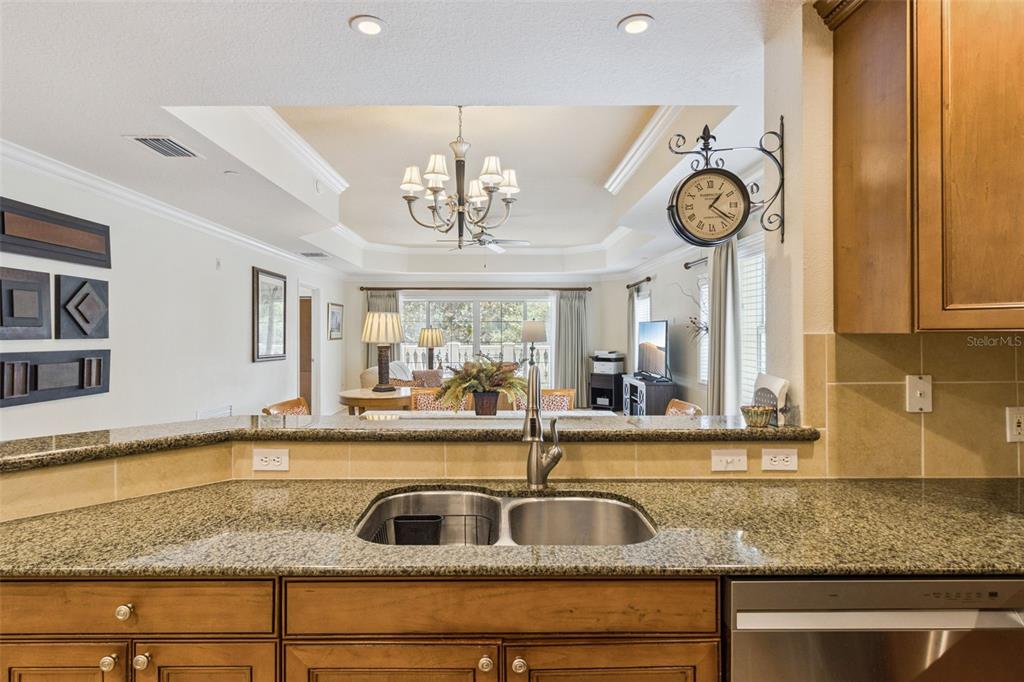 7650 Whisper Way, Unit 204 Reunion, FL 34747 - Photo 11 of 29 a view of a kitchen sink a faucet cabinets and a window