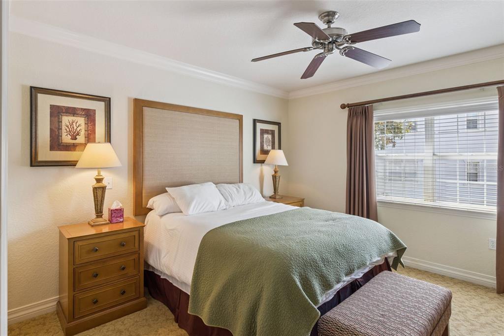 7650 Whisper Way, Unit 204 Reunion, FL 34747 - Photo 14 of 29 a bedroom with a large bed and a window