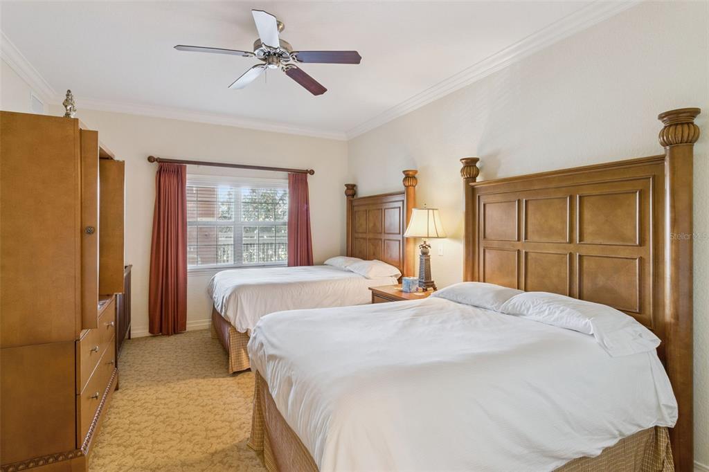 7650 Whisper Way, Unit 204 Reunion, FL 34747 - Photo 15 of 29 a bedroom with a large bed dresser and a window