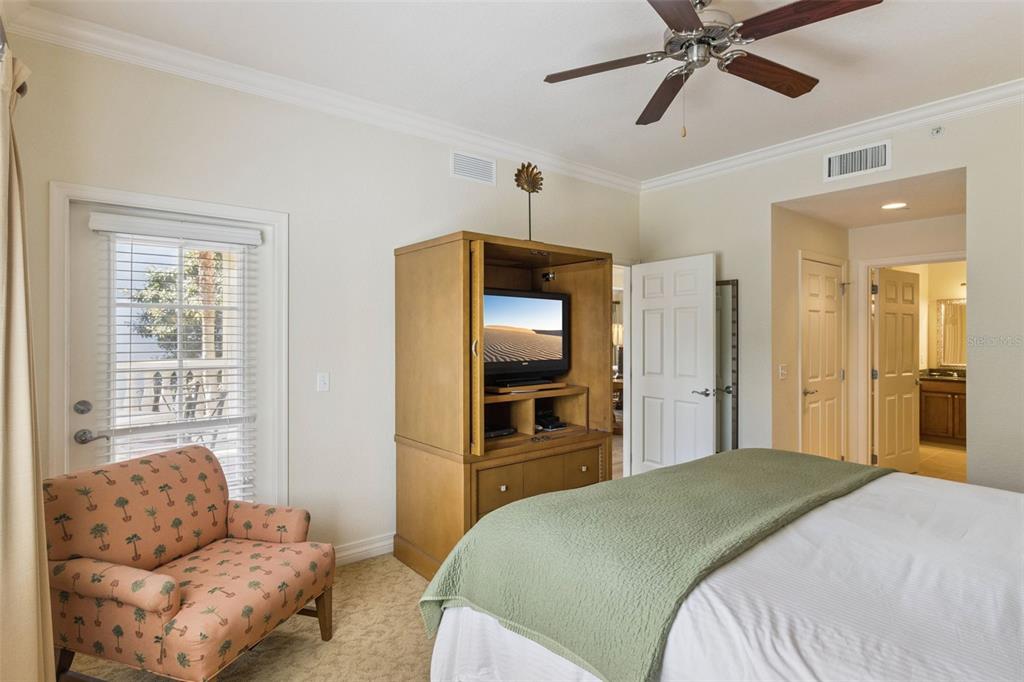 7650 Whisper Way, Unit 204 Reunion, FL 34747 - Photo 17 of 29 a bedroom with a bed and a couch