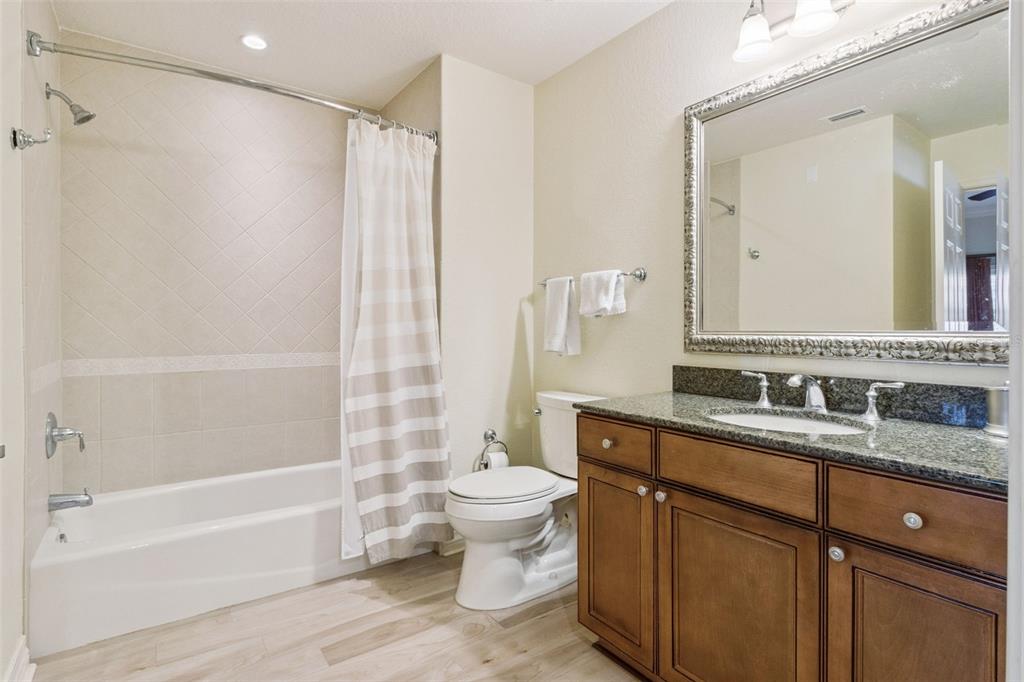 7650 Whisper Way, Unit 204 Reunion, FL 34747 - Photo 20 of 29 a bathroom with a granite countertop sink toilet and shower