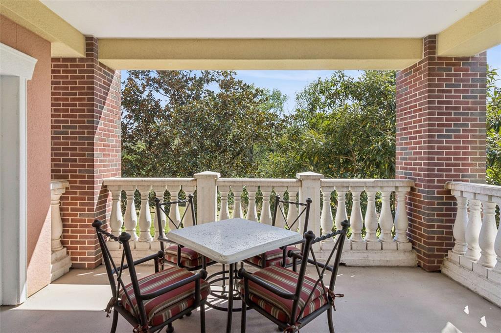 7650 Whisper Way, Unit 204 Reunion, FL 34747 - Photo 24 of 29 a view of a balcony with two chairs and a table