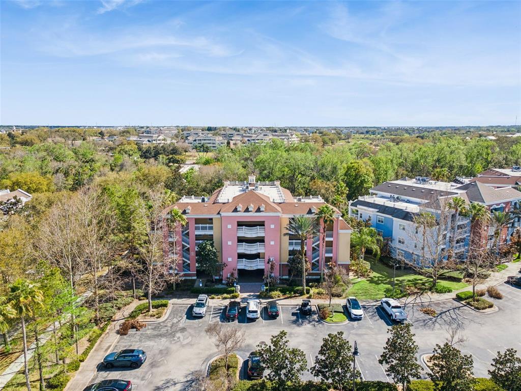 7650 Whisper Way, Unit 204 Reunion, FL 34747 - Photo 25 of 29 a front view of a building with lake view and mountain view in back