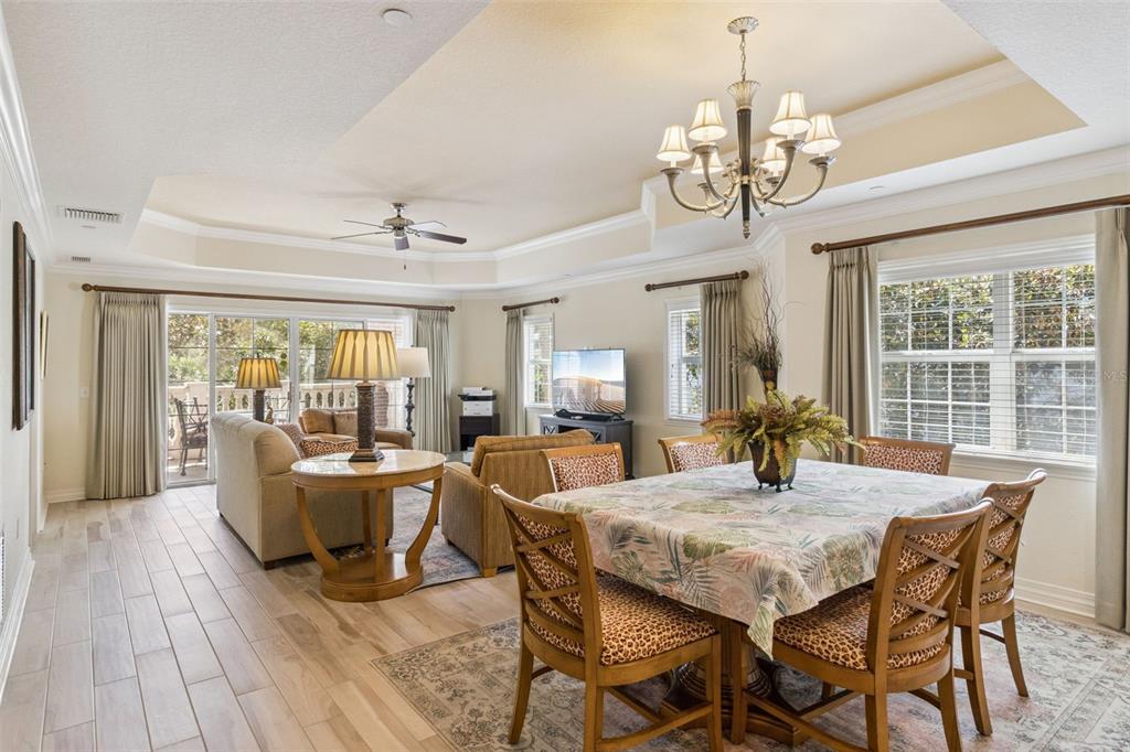 7650 Whisper Way, Unit 204 Reunion, FL 34747 - Photo 26 of 29 a view of a dining room with furniture wooden floor and chandelier
