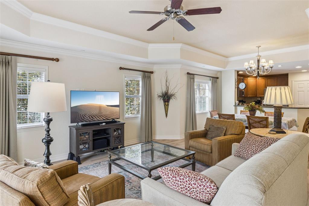 7650 Whisper Way, Unit 204 Reunion, FL 34747 - Photo 8 of 29 a living room with furniture a lamp and a flat screen tv