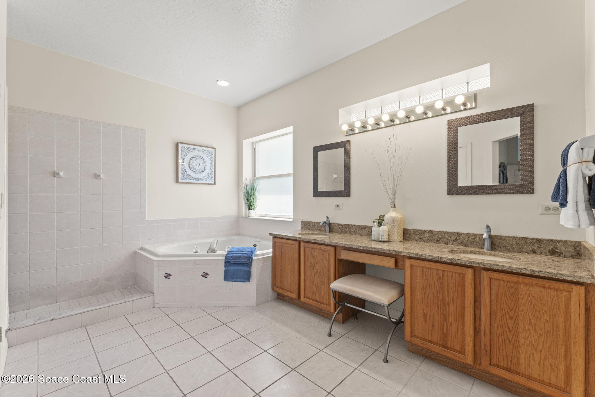 1123 Spring Oak Drive Melbourne, FL 32901 - Photo 36 of 67 a spacious bathroom with a granite countertop sink mirror and a