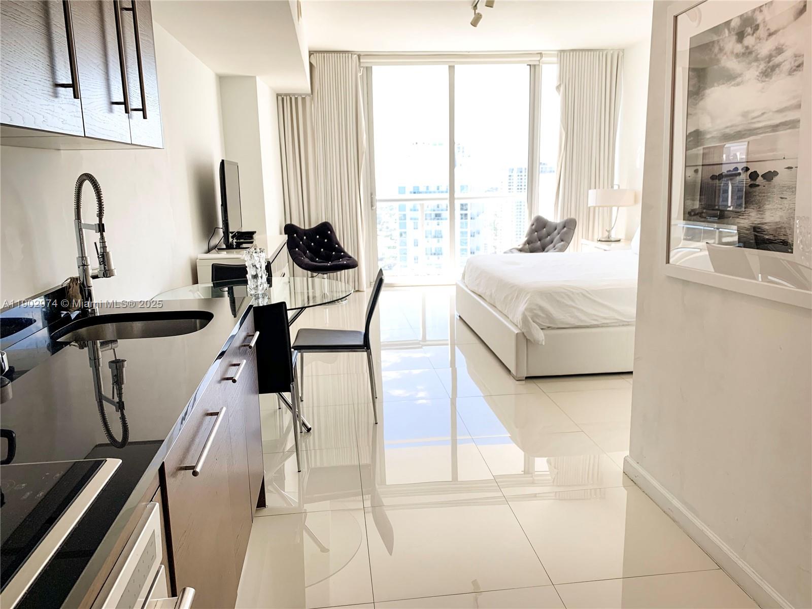 Icon Brickell Miami, FL 33131 - Photo 4 of 13 a living room with furniture and large windows