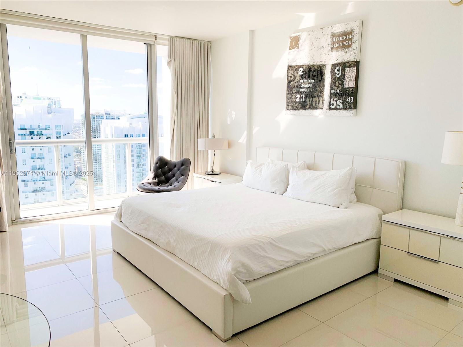 Icon Brickell Miami, FL 33131 - Photo 6 of 13 a bedroom with a bed and window