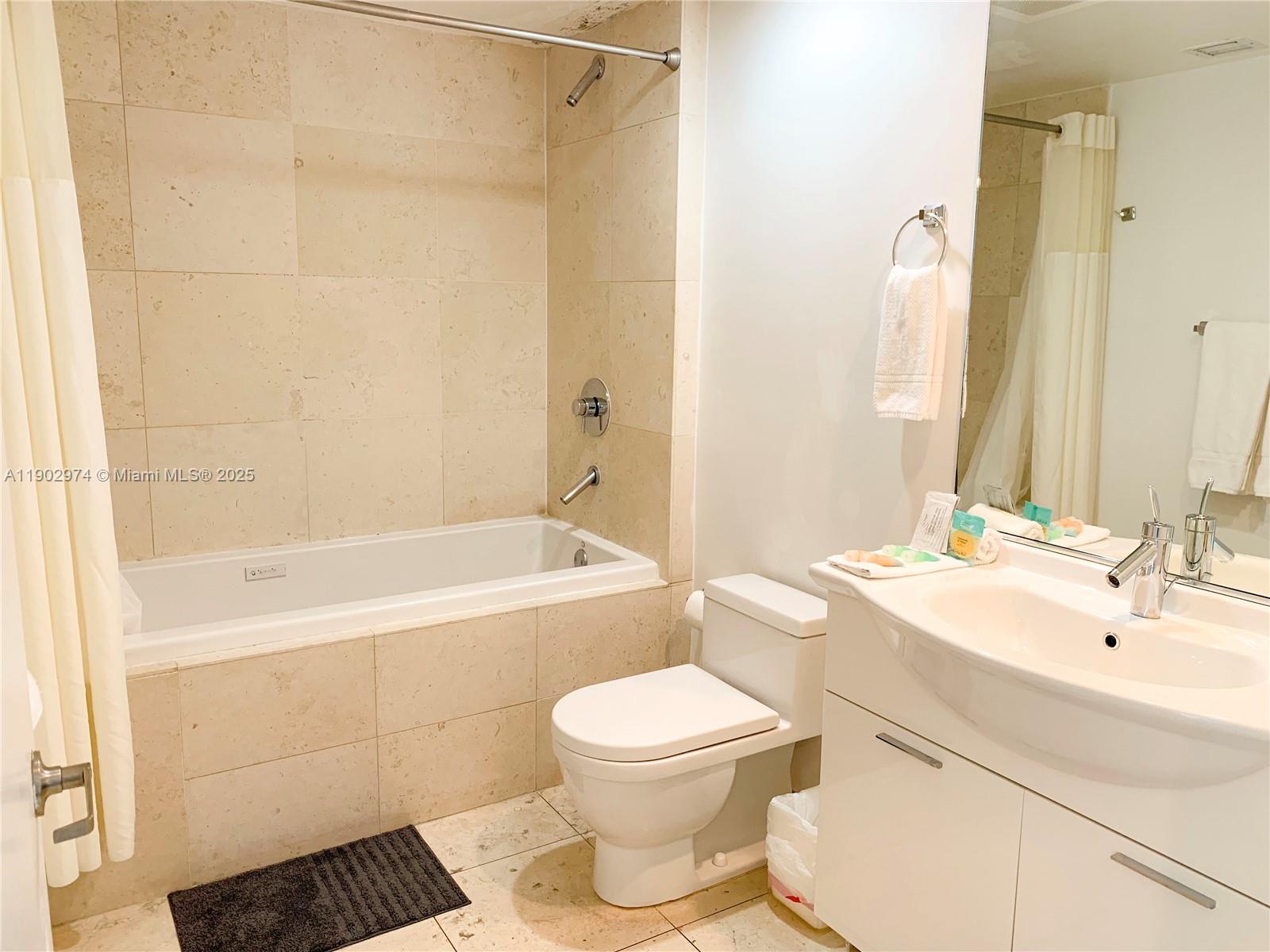 Icon Brickell Miami, FL 33131 - Photo 8 of 13 a bathroom with a toilet a sink and a bathtub