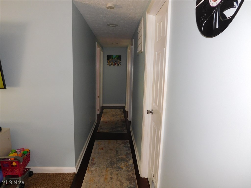581 Hadcock Road Brunswick, OH 44212 - Photo 15 of 22 Hallway featuring baseboards and a textured ceiling