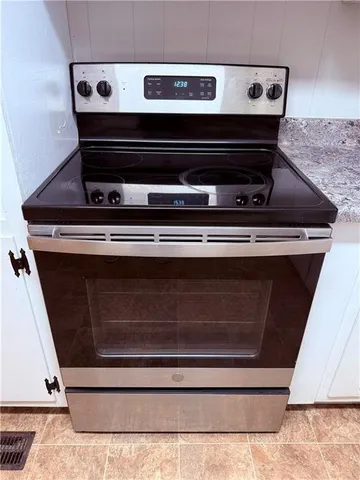 a kitchen with granite countertop a sink and cabinets