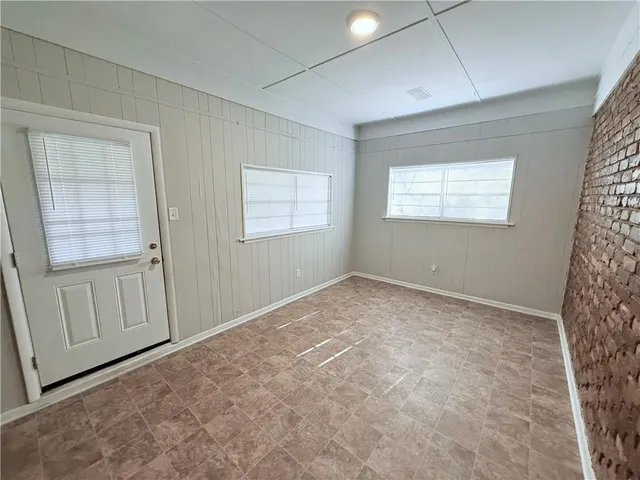 a view of large house with a yard and covered with snow