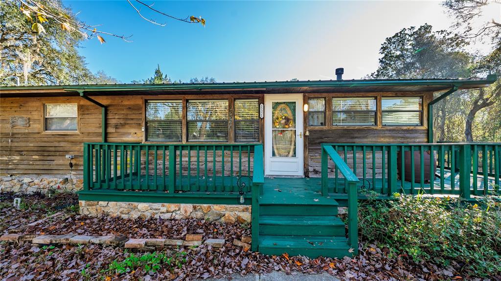 15321 Northeast 160th Avenue Road Salt Springs, FL 32134 - Photo 16 of 22 a view of a house with a yard
