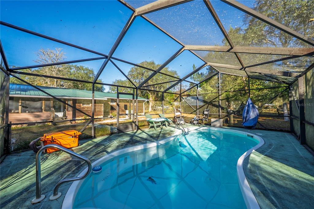 15321 Northeast 160th Avenue Road Salt Springs, FL 32134 - Photo 20 of 22 a view of backyard with a deck and flat screen tv