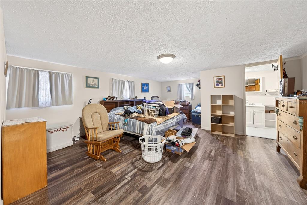 15321 Northeast 160th Avenue Road Salt Springs, FL 32134 - Photo 6 of 22 a living room with furniture and a wooden floor