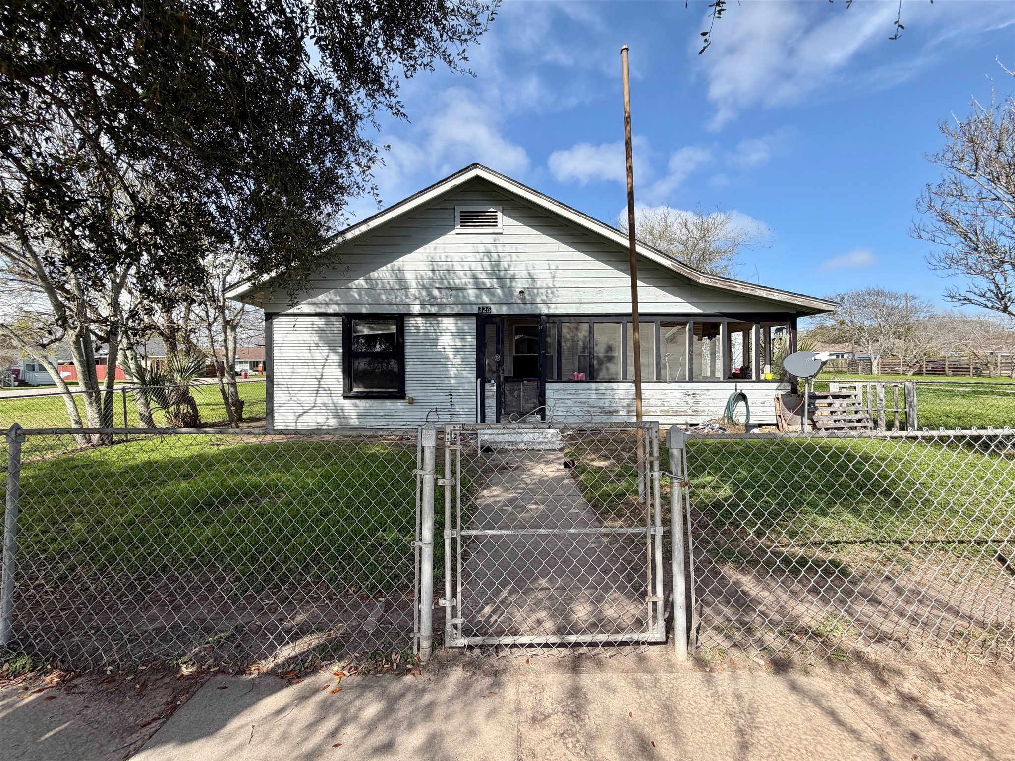 326 West 2nd Street Freeport, TX 77541 - Photo 1 of 24 a front view of a house with a porch