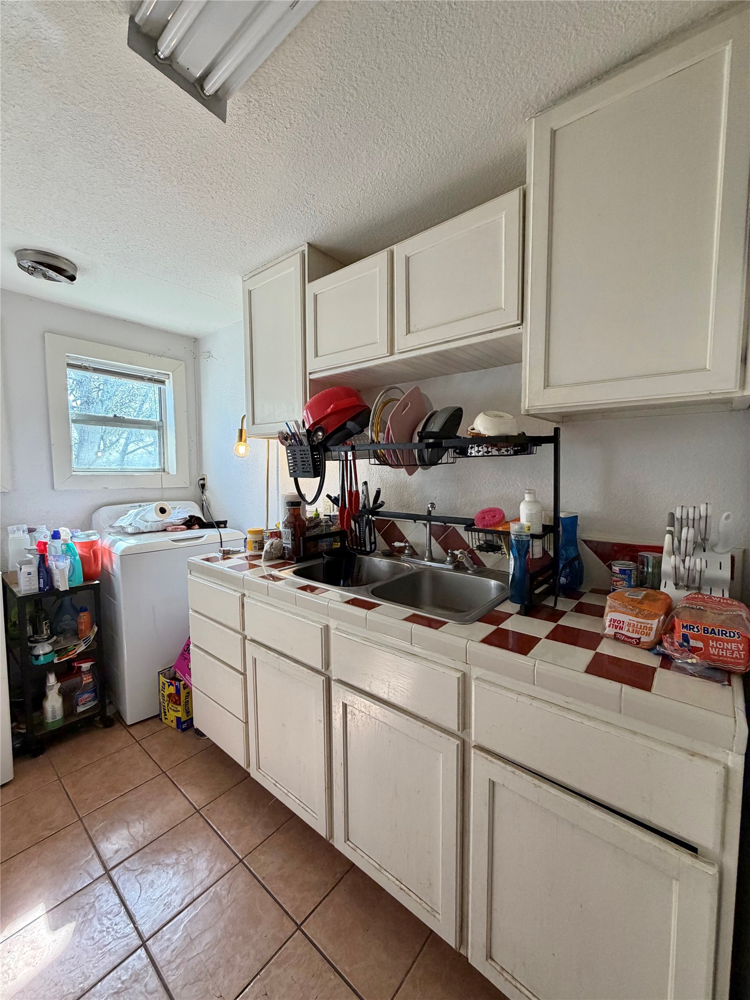 326 West 2nd Street Freeport, TX 77541 - Photo 11 of 24 a kitchen with cabinets a sink and a stove top oven