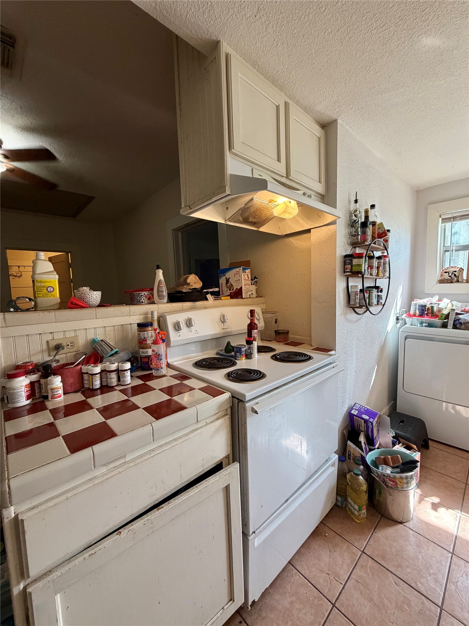 326 West 2nd Street Freeport, TX 77541 - Photo 12 of 24 a kitchen with a stove and cabinets