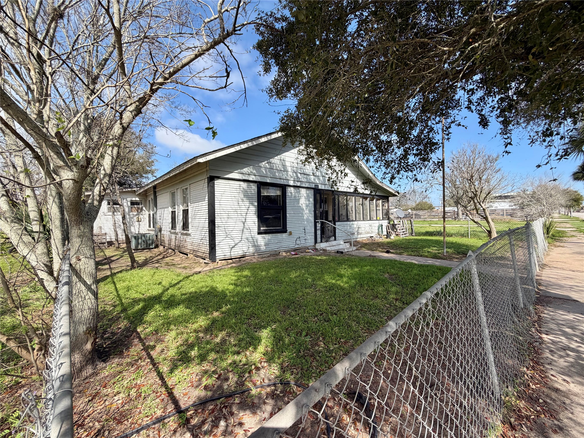 326 West 2nd Street Freeport, TX 77541 - Photo 2 of 24 a front view of a house with garden