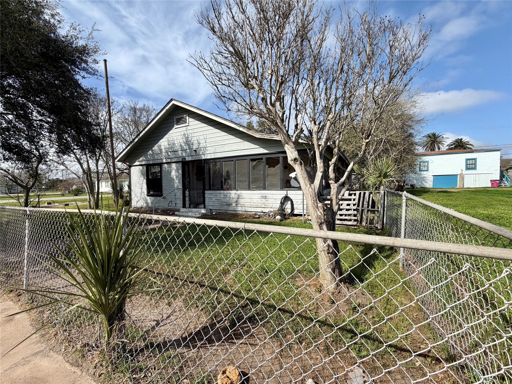 326 West 2nd Street Freeport, TX 77541 - Photo 3 of 24 a front view of a house with a yard