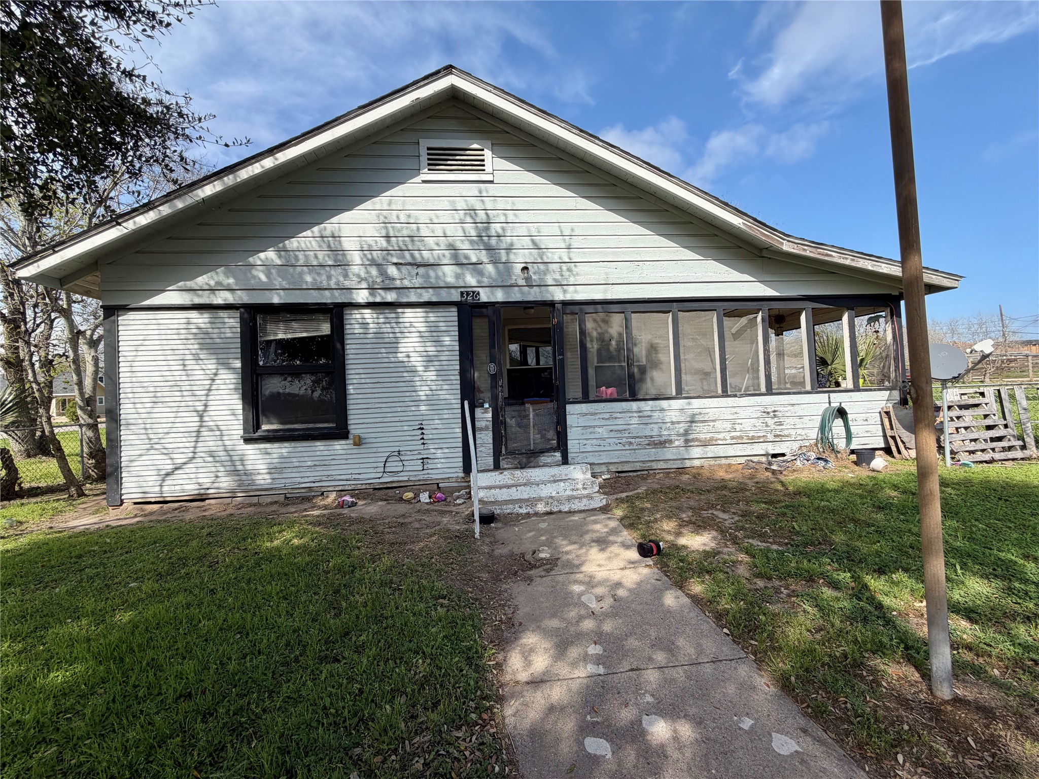 326 West 2nd Street Freeport, TX 77541 - Photo 4 of 24 a front view of a house with a yard