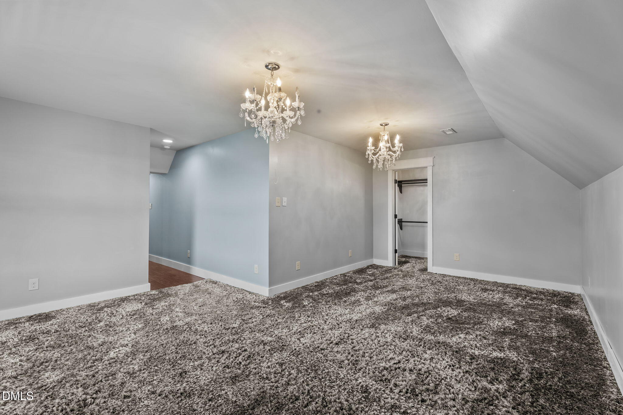 6559 Dolphus Lane Sims, NC 27880 - Photo 28 of 43 an empty room with chandelier fan and kitchen view