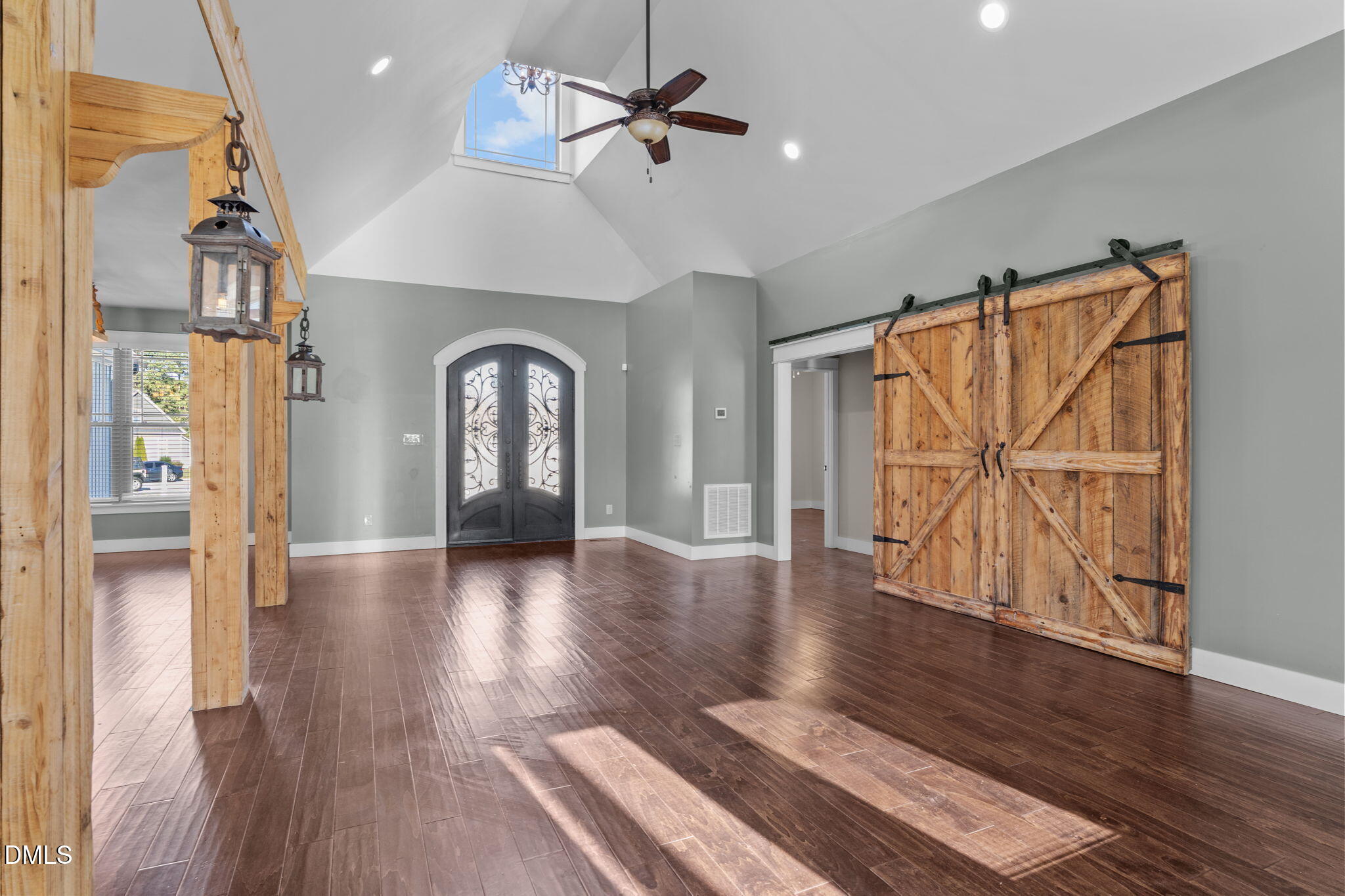 6559 Dolphus Lane Sims, NC 27880 - Photo 6 of 43 a view of a livingroom with wooden floor a ceiling fan and windows